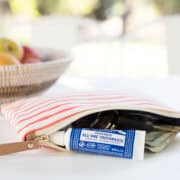 Travel-size toothpaste next to a wallet