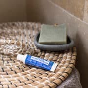 Travel-size toothpaste on top of a lid