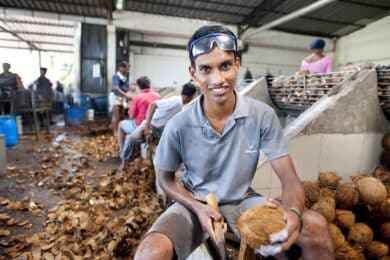A Serendipol worker processing coconut