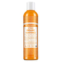 A bottle of Dr. Bronners Citrus Organic Hair Rinse stands upright. The orange bottle features detailed text about its conditioning benefits with shikakai for shiny, silky hair. Label promotes fair trade and organic certification [8 oz]