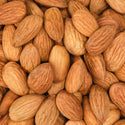 Close up of numerous whole almonds, characterized by their textured, brown shells. They are tightly clustered together, creating a natural, organic pattern. Perfect imagery for promoting natural products like organic soap or eco friendly skincare items [5 oz]